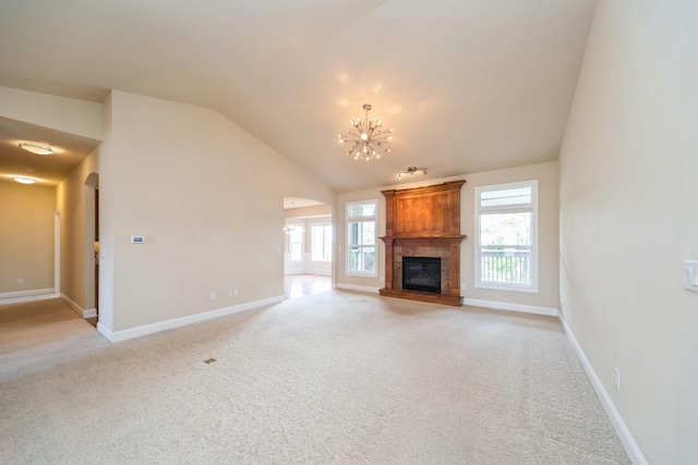 1420 Hannah Ln, Waukee, IA 50263 - unfurnished living room with arched walkways, light carpet, lofted ceiling, a chandelier, and baseboards