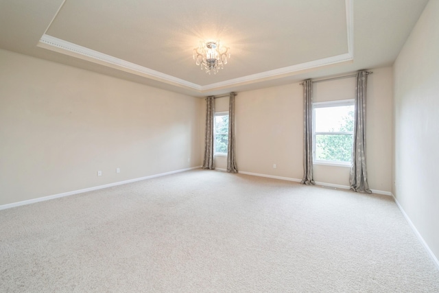 1420 Hannah Ln, Waukee, IA 50263 - carpeted spare room featuring a raised ceiling, healthy amount of natural light, a chandelier, baseboards, and crown molding