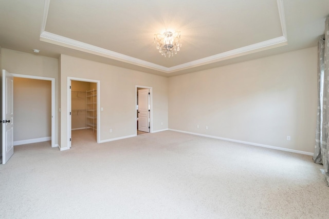 1420 Hannah Ln, Waukee, IA 50263 - unfurnished bedroom featuring a raised ceiling, ornamental molding, a chandelier, light colored carpet, and baseboards