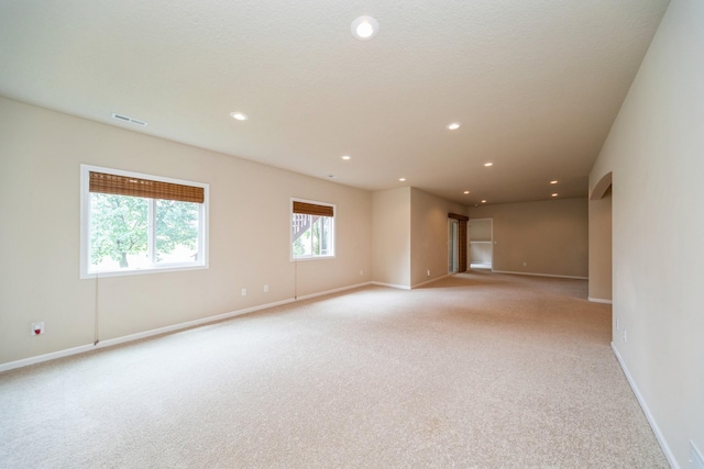 1420 Hannah Ln, Waukee, IA 50263 - spare room featuring light colored carpet, baseboards, and recessed lighting