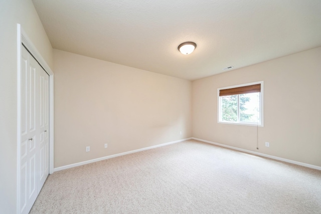 1420 Hannah Ln, Waukee, IA 50263 - unfurnished bedroom featuring light colored carpet, baseboards, and a closet