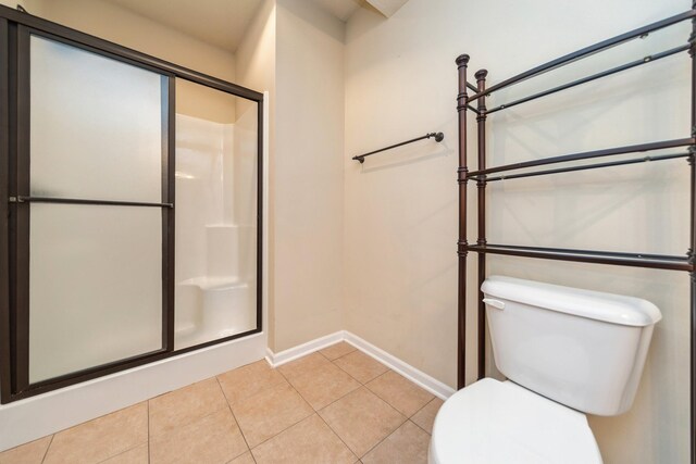 1420 Hannah Ln, Waukee, IA 50263 - bathroom with toilet, a stall shower, tile patterned floors, and baseboards