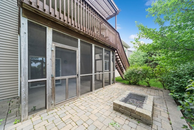1420 Hannah Ln, Waukee, IA 50263 - view of patio / terrace featuring stairway, a sunroom, and an outdoor fire pit