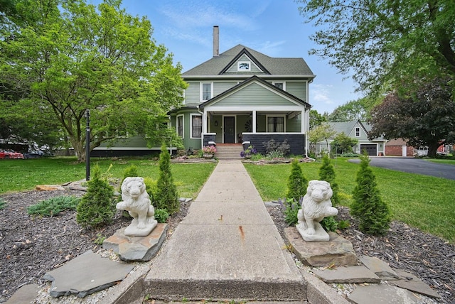207 Kellogg Ave, Dallas Center, IA 50063 - view of front facade with covered porch, a front lawn, and a chimney