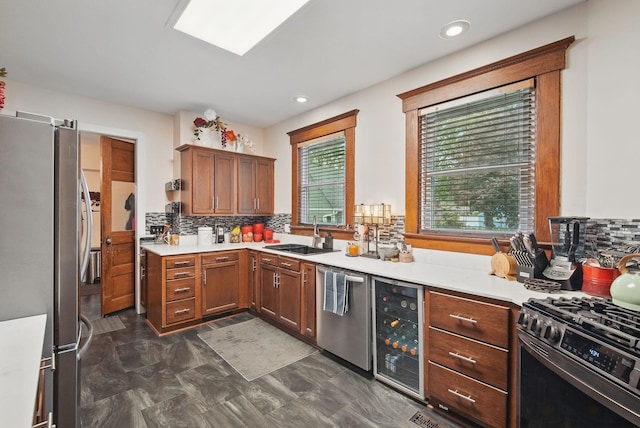 207 Kellogg Ave, Dallas Center, IA 50063 - kitchen with stainless steel appliances, beverage cooler, decorative backsplash, light countertops, and recessed lighting
