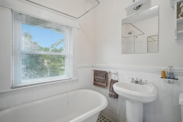 207 Kellogg Ave, Dallas Center, IA 50063 - bathroom with a freestanding bath, wainscoting, and a shower