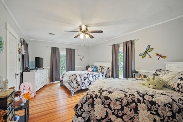 207 Kellogg Ave, Dallas Center, IA 50063 - bedroom with light wood-type flooring, crown molding, and ceiling fan