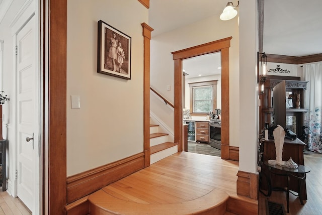207 Kellogg Ave, Dallas Center, IA 50063 - hallway featuring light wood-style flooring, beverage cooler, and stairway