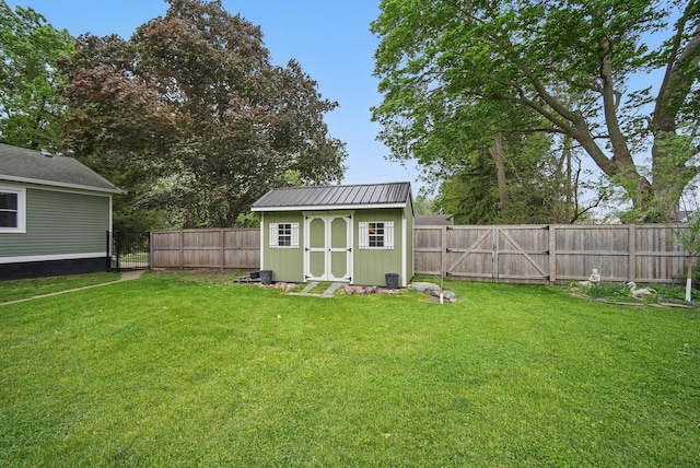 207 Kellogg Ave, Dallas Center, IA 50063 - view of yard featuring a gate, a storage unit, and an outbuilding
