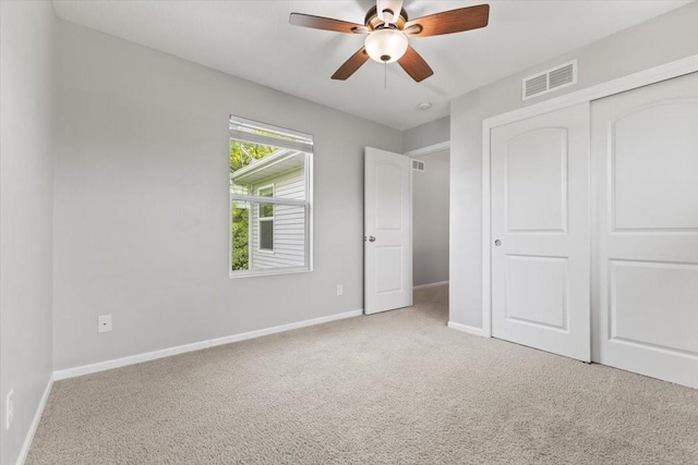 unfurnished bedroom with carpet, baseboards, a closet, and ceiling fan