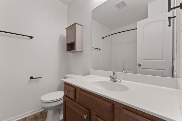 full bath featuring toilet, vanity, baseboards, and a shower