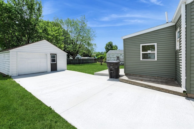 2311 50th St, Des Moines, IA 50310 - view of patio / terrace featuring a detached garage, an outdoor structure, and concrete driveway