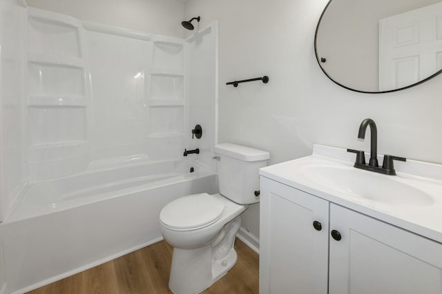 2311 50th St, Des Moines, IA 50310 - full bathroom with wood finished floors, toilet, vanity, and  shower combination