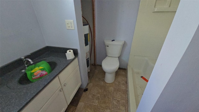 308 N Cherry St, Creston, IA 50801 - bathroom featuring toilet, vanity, tile patterned flooring, and a bath