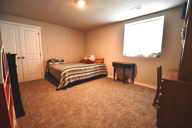 2010 N 7th St, Indianola, IA 50125 - bedroom with carpet flooring, a textured ceiling, baseboards, and a closet