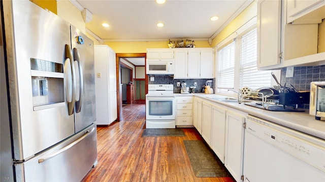 1415 46th St, Des Moines, IA 50311 - kitchen with white appliances, light countertops, decorative backsplash, dark wood-style floors, and white cabinetry