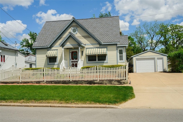 320 E 3rd St S, Newton, IA 50208 - victorian home featuring a detached garage, an outdoor structure, a fenced front yard, and driveway