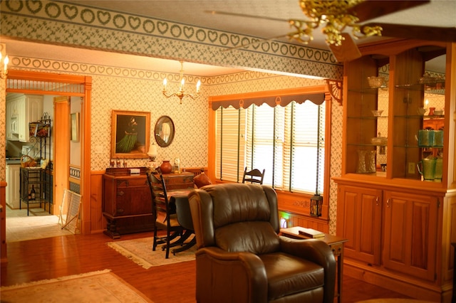 320 E 3rd St S, Newton, IA 50208 - living area with wallpapered walls, a chandelier, and wood finished floors