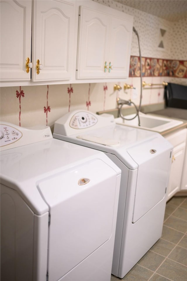 320 E 3rd St S, Newton, IA 50208 - laundry room featuring cabinet space, independent washer and dryer, wallpapered walls, and tile patterned flooring