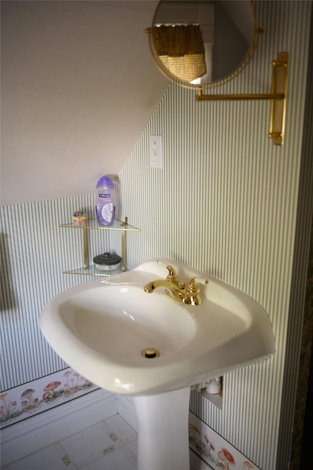 320 E 3rd St S, Newton, IA 50208 - bathroom featuring wallpapered walls, marble look tiles, and a sink