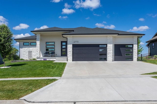 2770 NW 167th St, Clive, IA 50325 - prairie-style home with stone siding, an attached garage, concrete driveway, and stucco siding