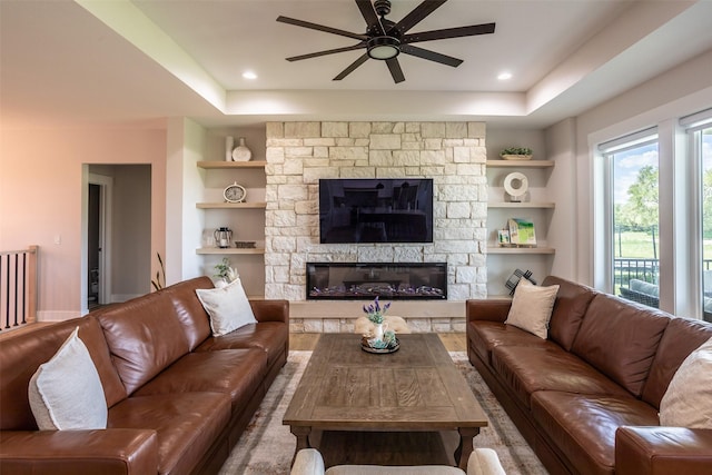 2770 NW 167th St, Clive, IA 50325 - living area featuring a ceiling fan, a fireplace, a raised ceiling, built in features, and recessed lighting