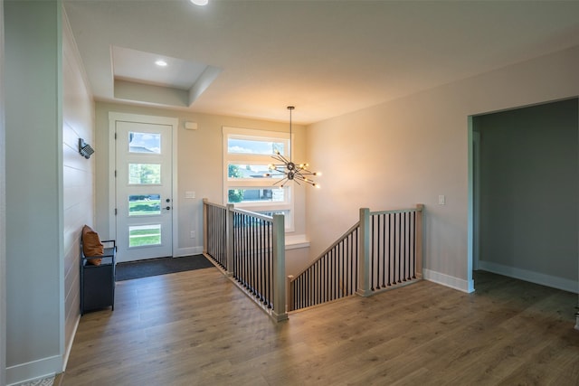 2770 NW 167th St, Clive, IA 50325 - foyer featuring a chandelier, wood finished floors, baseboards, a tray ceiling, and recessed lighting