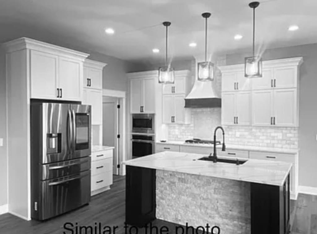 18099 Townsend Dr, Clive, IA 50325 - kitchen featuring stainless steel appliances, a sink, premium range hood, baseboards, and dark wood finished floors