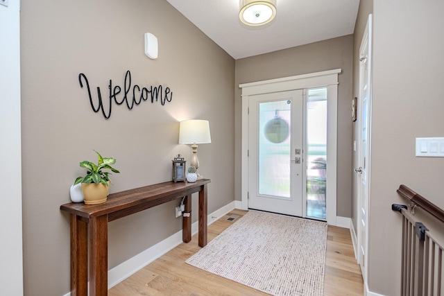 foyer featuring light wood-type flooring and baseboards
