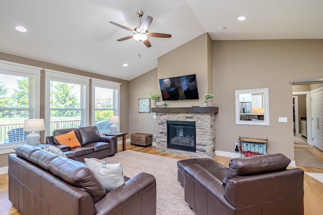living area with lofted ceiling, ceiling fan, a fireplace, light wood-style flooring, and recessed lighting