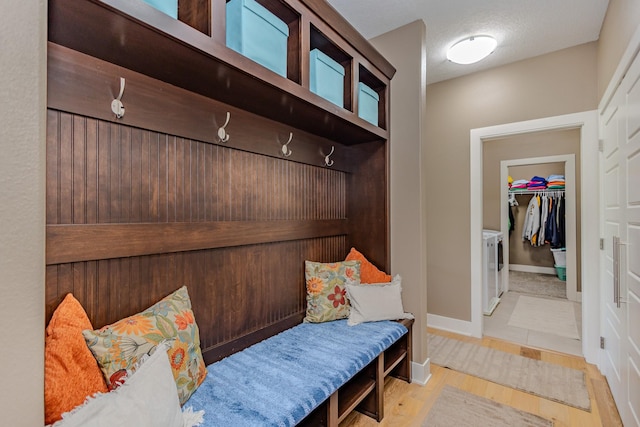 mudroom with wood finished floors and baseboards