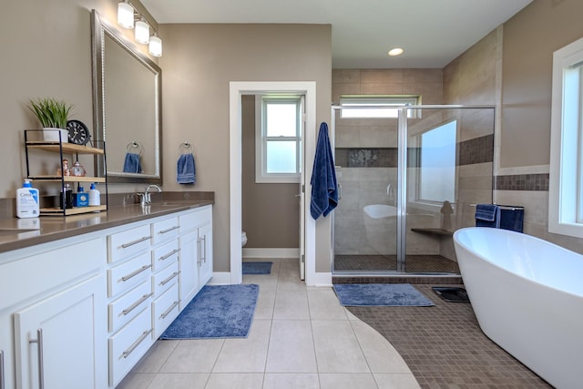 full bathroom with a shower stall, vanity, tile patterned floors, a soaking tub, and recessed lighting
