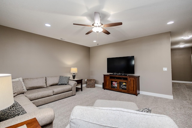 carpeted living room with a ceiling fan, baseboards, and recessed lighting