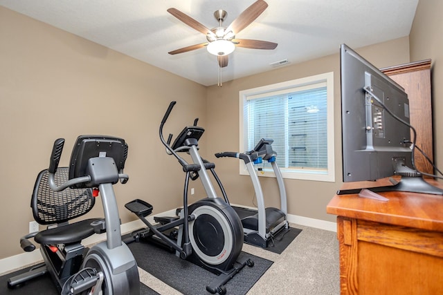 workout area with ceiling fan, baseboards, and carpet floors