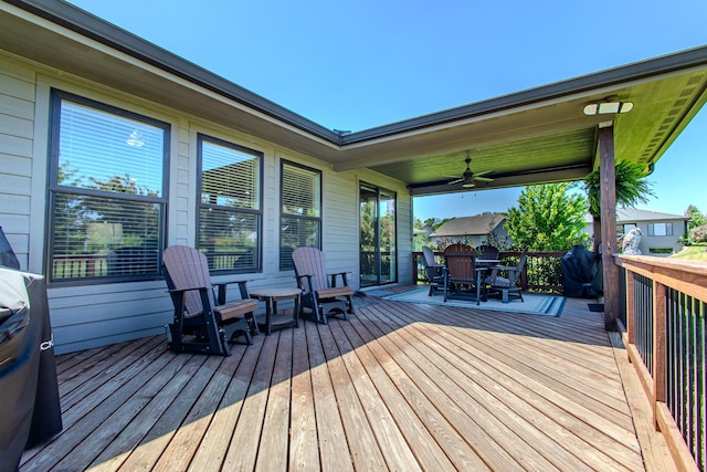 wooden terrace featuring outdoor dining area and ceiling fan