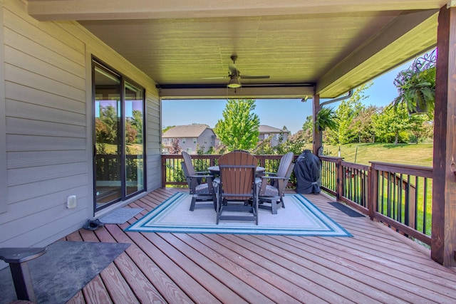 wooden terrace featuring outdoor dining area and ceiling fan