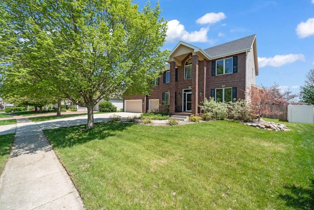 947 11th Ave SE, Altoona, IA 50009 - view of front of property with brick siding and concrete driveway