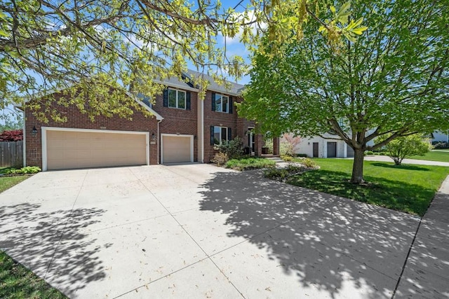 947 11th Ave SE, Altoona, IA 50009 - view of front of property featuring driveway, brick siding, and a garage