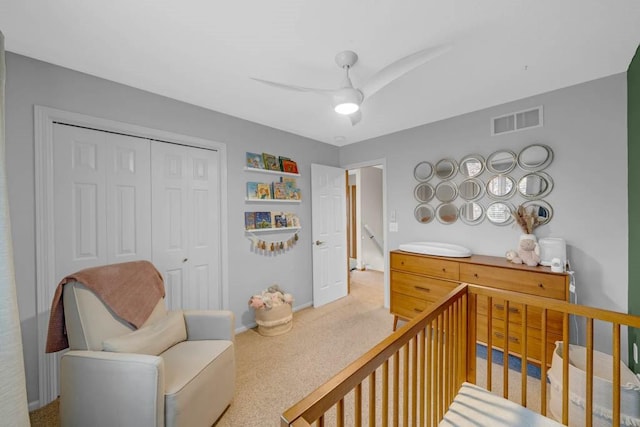 947 11th Ave SE, Altoona, IA 50009 - carpeted bedroom with a closet, a crib, a ceiling fan, and baseboards