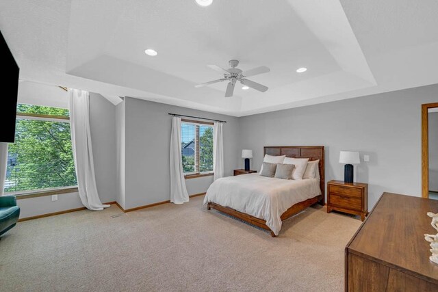 947 11th Ave SE, Altoona, IA 50009 - bedroom featuring a raised ceiling, light carpet, baseboards, recessed lighting, and ceiling fan