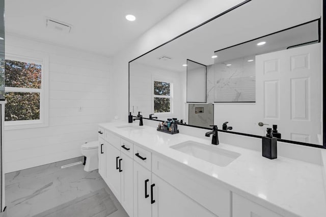 947 11th Ave SE, Altoona, IA 50009 - full bathroom featuring marble finish flooring, toilet, double vanity, a tile shower, and recessed lighting
