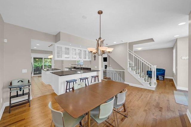 947 11th Ave SE, Altoona, IA 50009 - dining room featuring a chandelier, stairway, light wood-type flooring, baseboards, and recessed lighting
