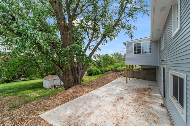 208 Van Buren Dr, Van Meter, IA 50261 - view of patio / terrace with a storage unit and an outdoor structure