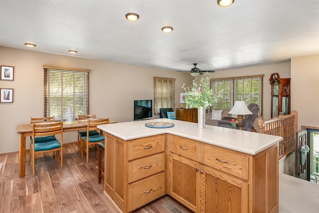 308 Nevada St, Glidden, IA 51443 - kitchen with light wood-style floors, a ceiling fan, light countertops, and open floor plan