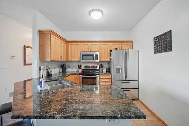545 Maggie Ln, Altoona, IA 50009 - kitchen with appliances with stainless steel finishes, a sink, a peninsula, tasteful backsplash, and baseboards