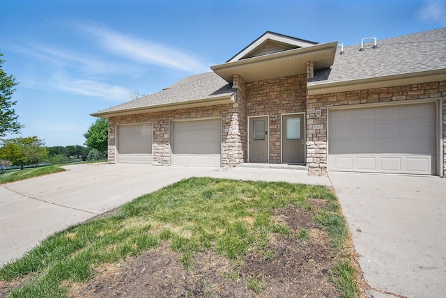 545 Maggie Ln, Altoona, IA 50009 - view of front of home with concrete driveway, stone siding, a shingled roof, and a garage