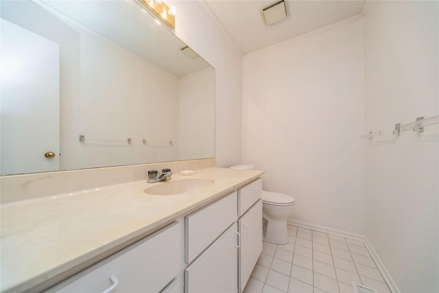 bathroom featuring tile patterned flooring, vanity, toilet, and baseboards