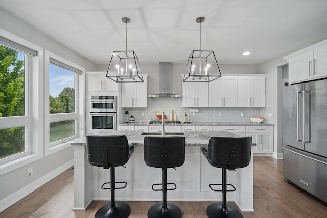 16202 Brookview Dr, Urbandale, IA 50323 - kitchen featuring stainless steel appliances, wall chimney exhaust hood, backsplash, a chandelier, and recessed lighting