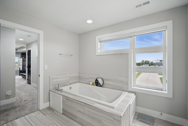 16202 Brookview Dr, Urbandale, IA 50323 - bathroom featuring a whirlpool tub and baseboards