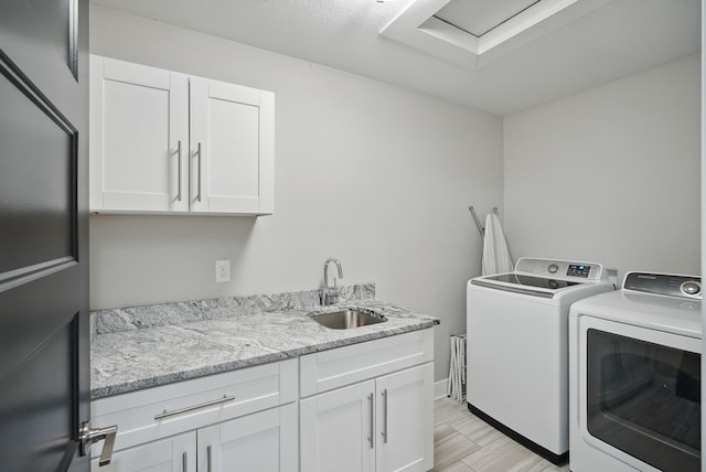 16202 Brookview Dr, Urbandale, IA 50323 - clothes washing area featuring washing machine and dryer, cabinet space, and light wood-type flooring